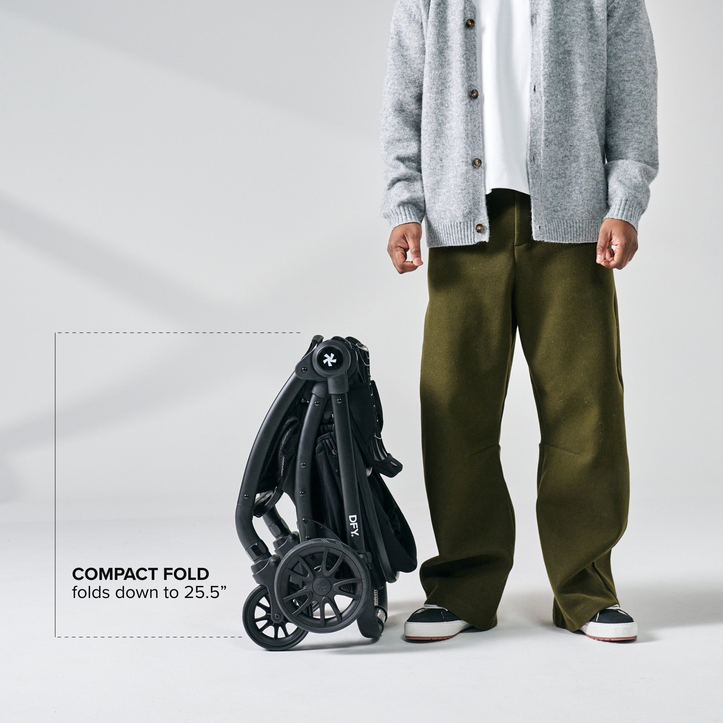 Image with dad stood next to folded stroller