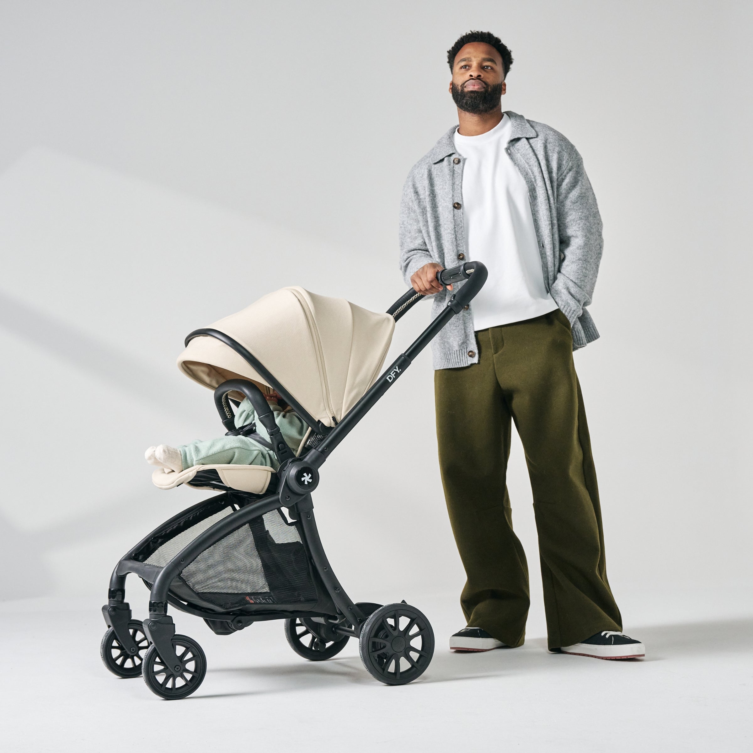 image of dad holding cream stroller