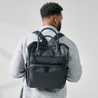 shot of dad wearing diaper backpack