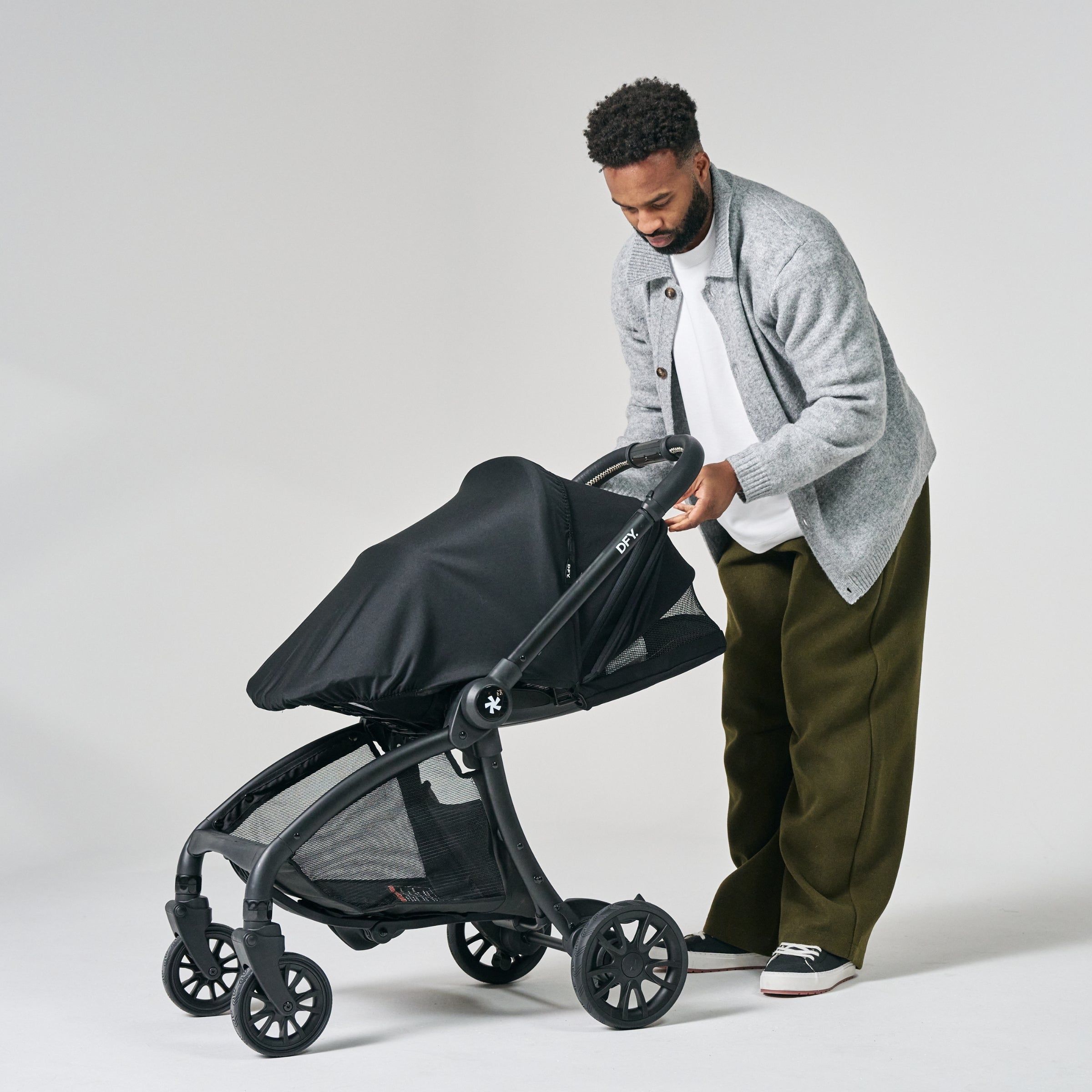 Image of Dad putting the sunshade on the stroller