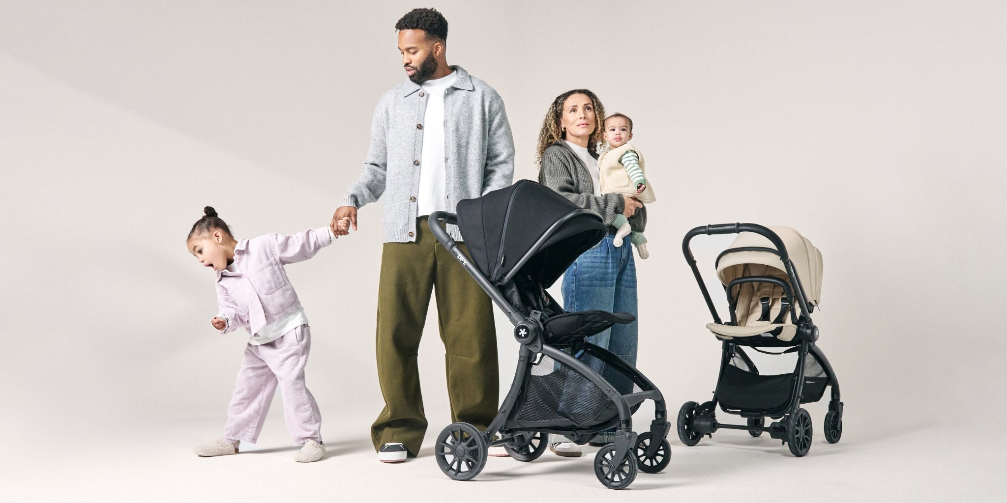 studio show of mum, dad and 2 kids with stroller
